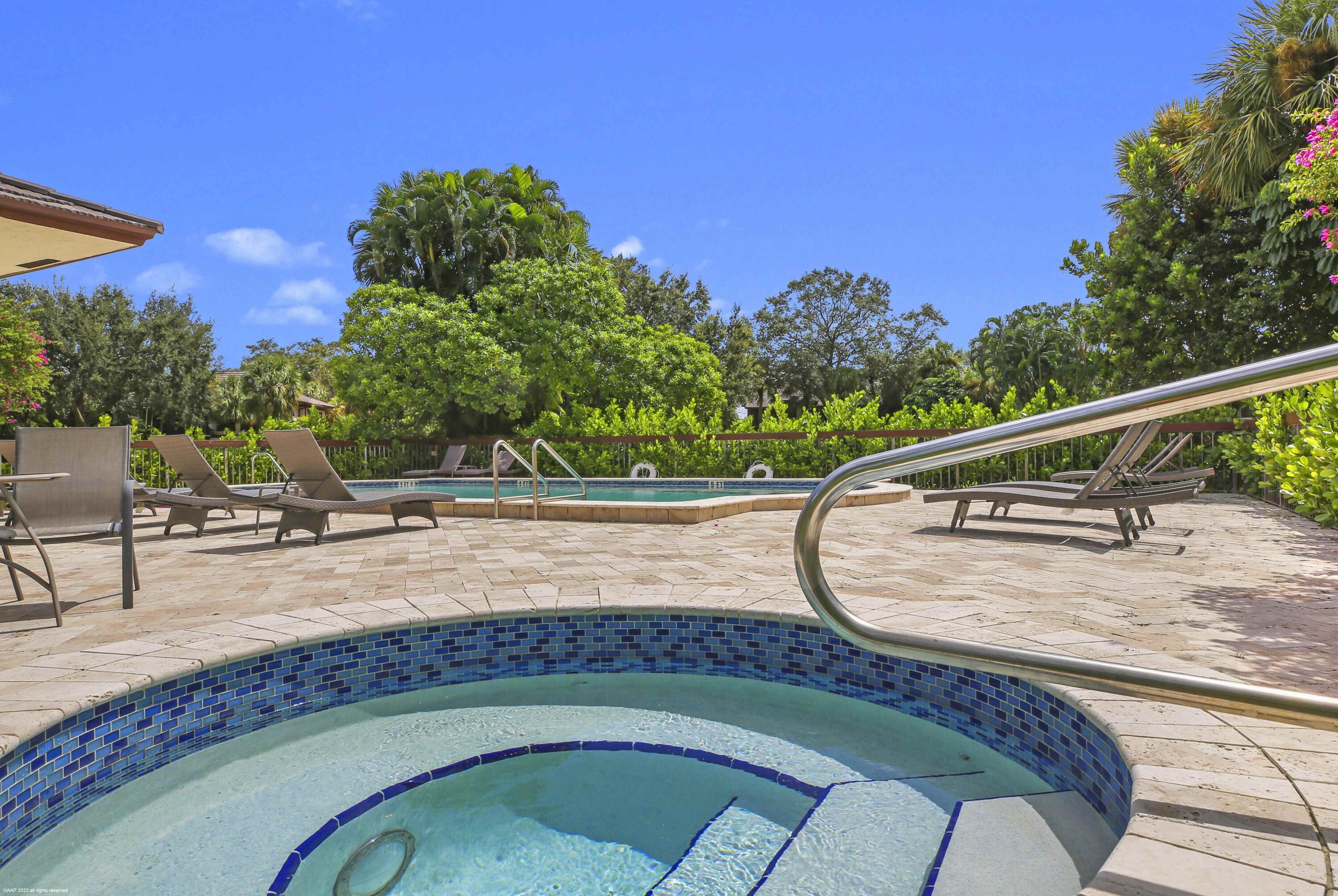 13334 Polo Club Road, Unit 346 Wellington, FL 33414 - Photo 16 of 19 a view of a swimming pool with a patio