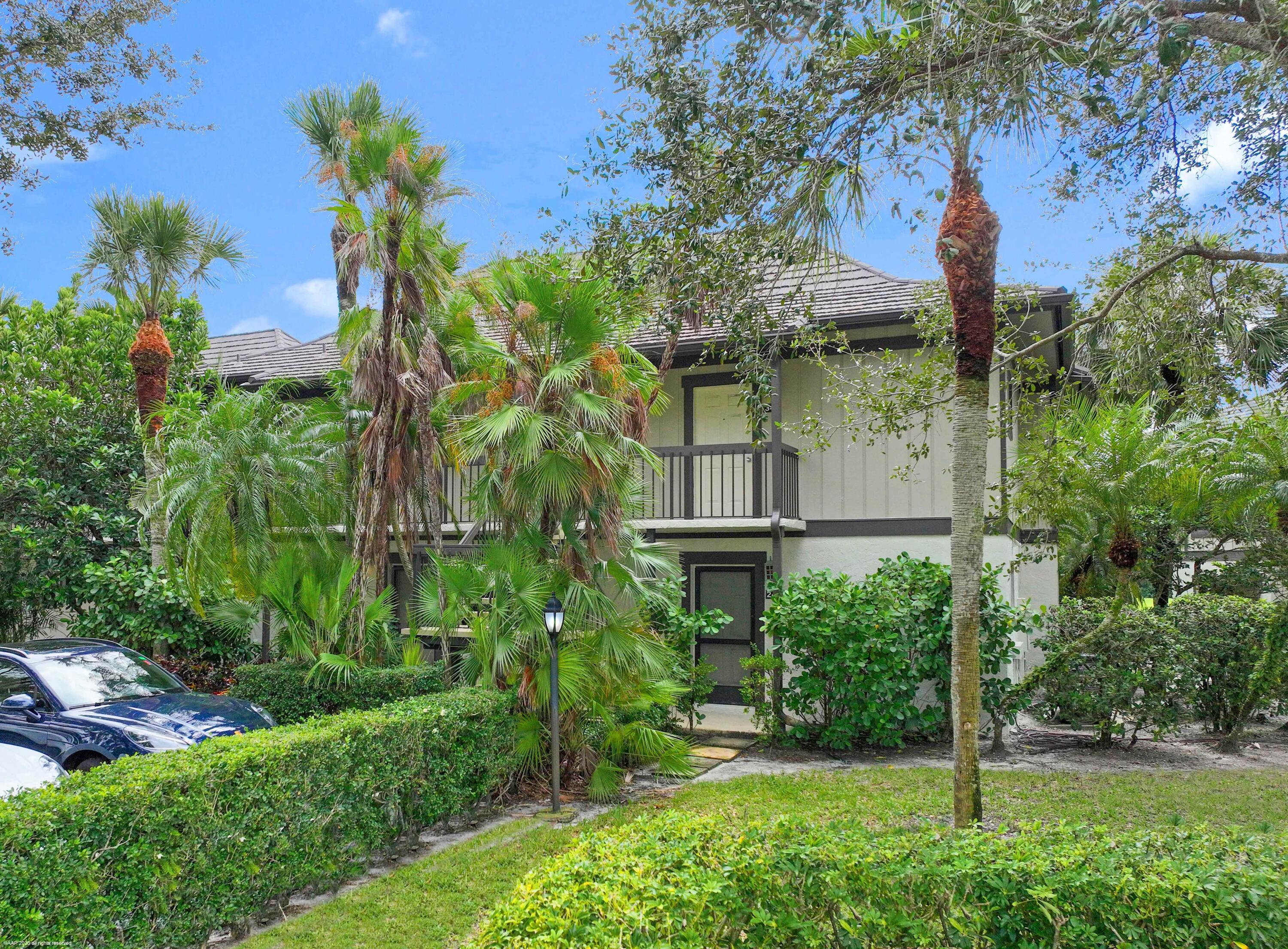 13334 Polo Club Road, Unit 346 Wellington, FL 33414 - Photo 18 of 19 a front view of a house with a yard