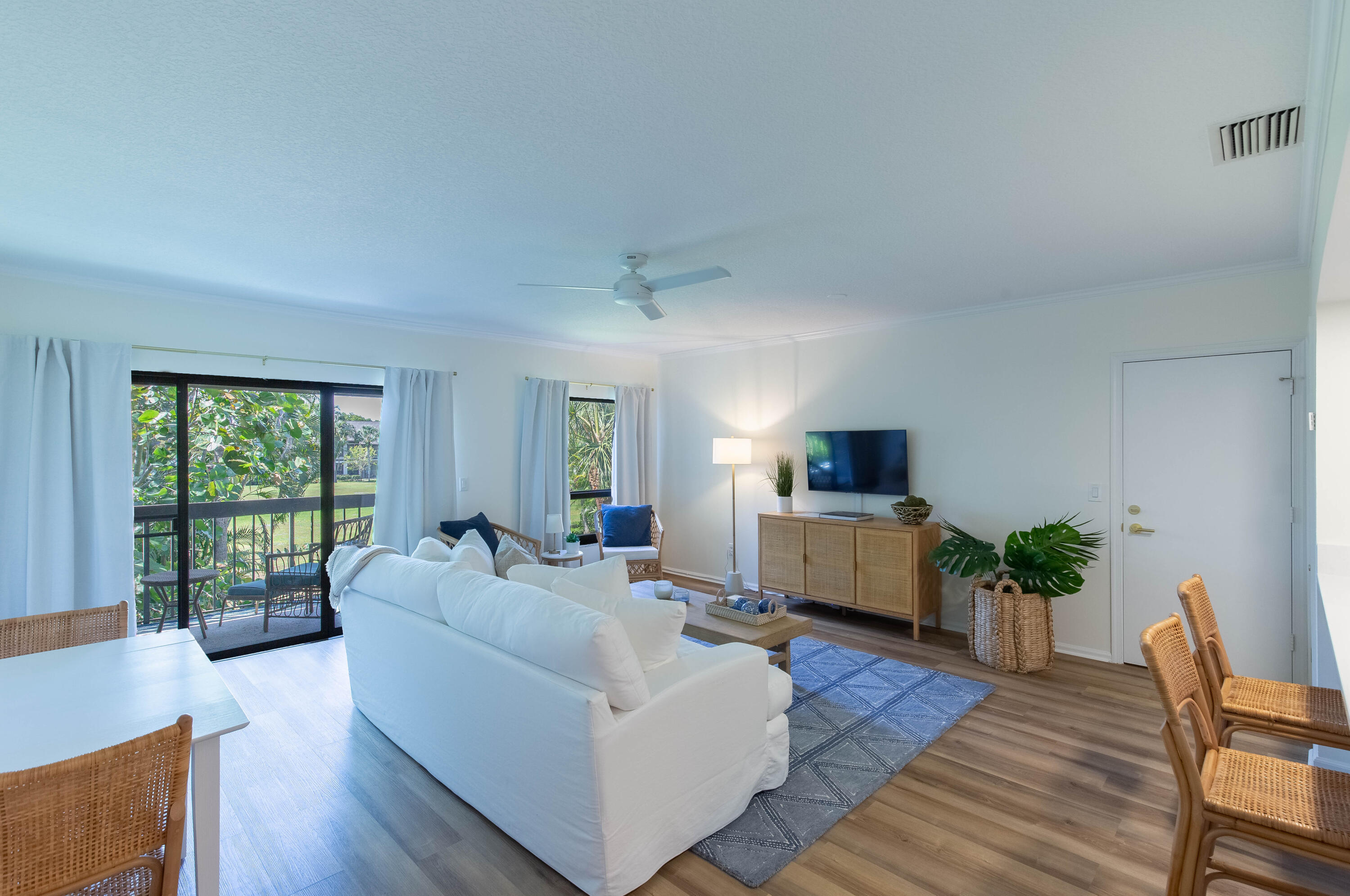 13334 Polo Club Road, Unit 346 Wellington, FL 33414 - Photo 2 of 19 a living room with furniture and a flat screen tv