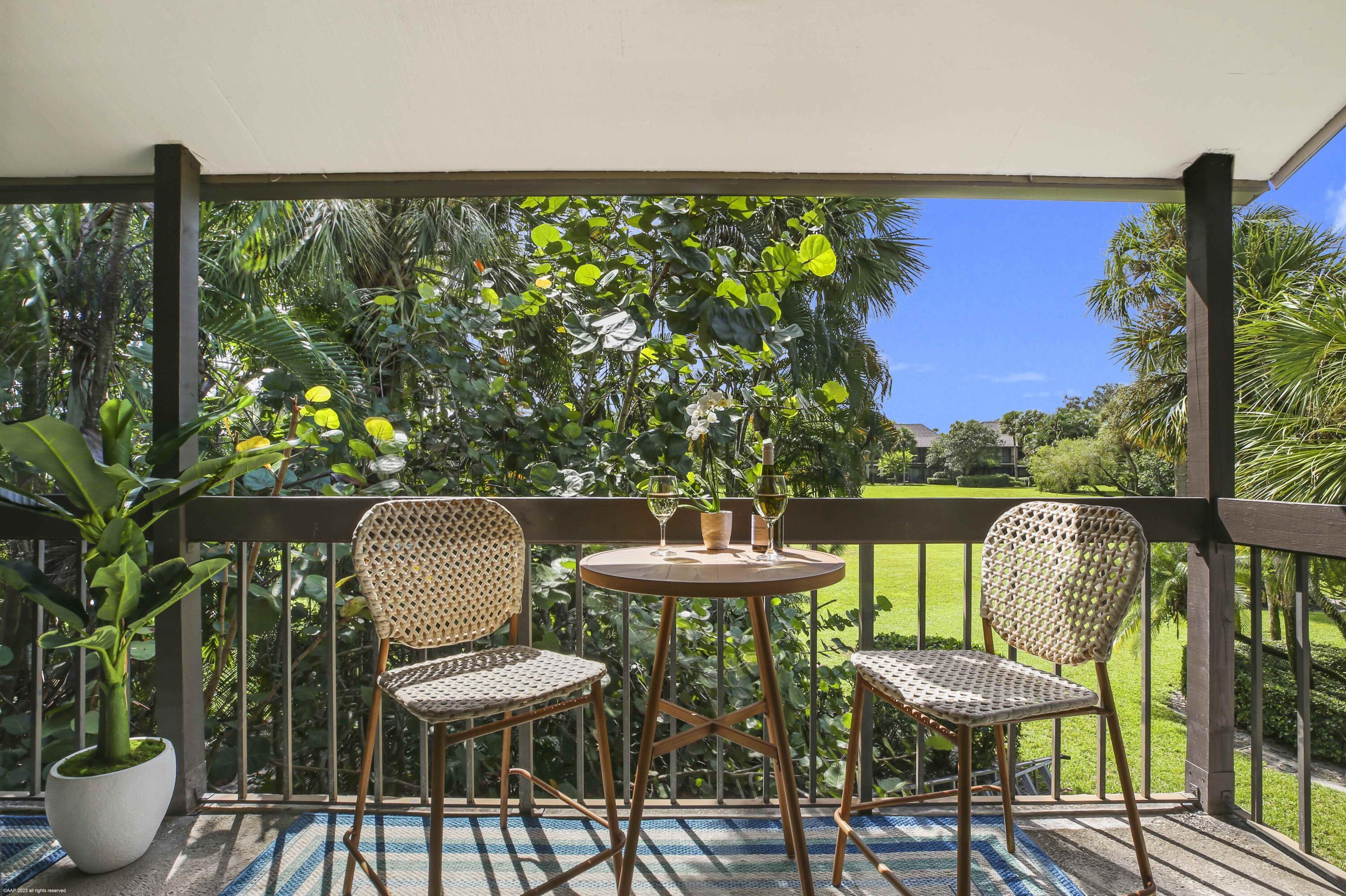 13334 Polo Club Road, Unit 346 Wellington, FL 33414 - Photo 4 of 19 a view of a chairs and table in patio