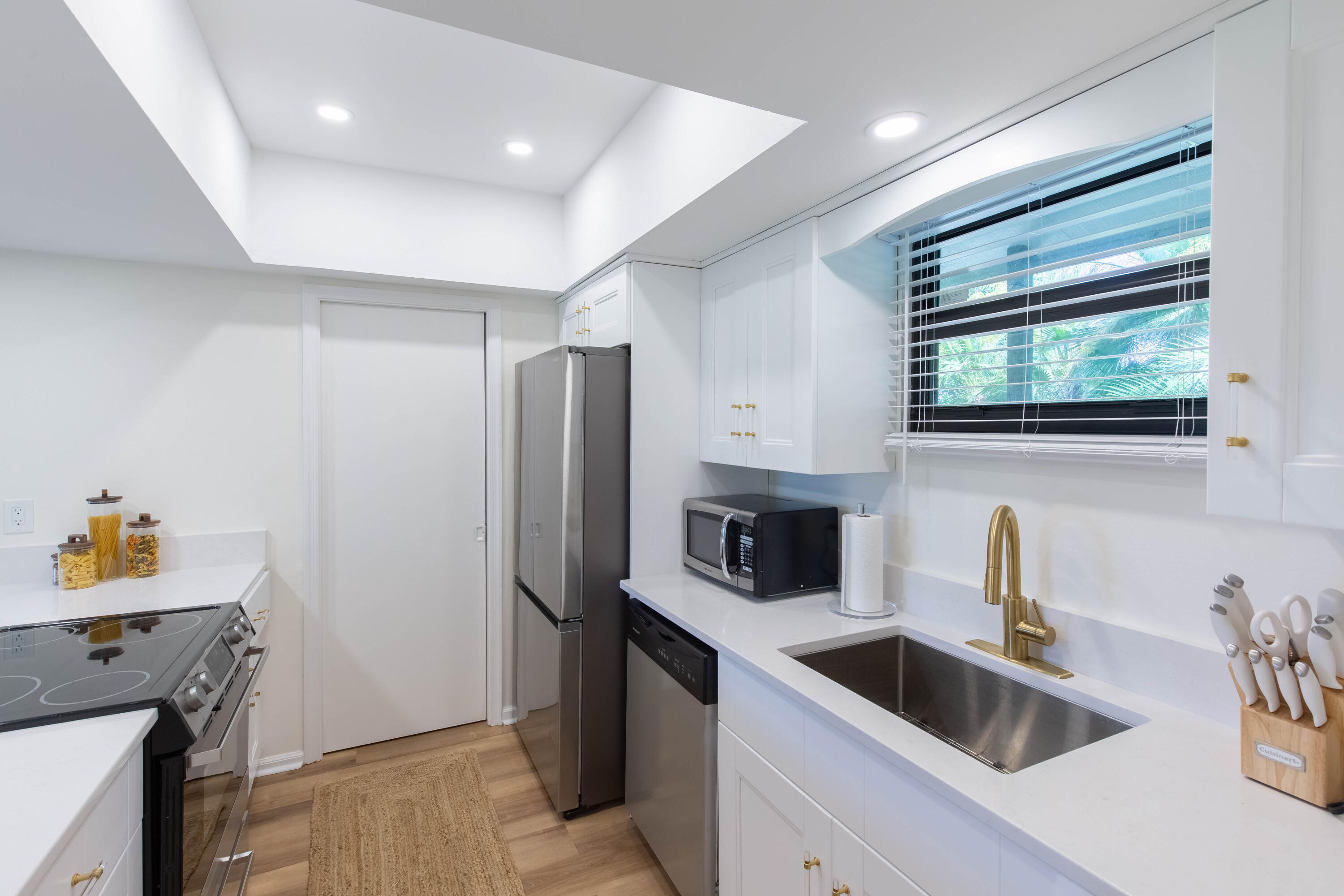 13334 Polo Club Road, Unit 346 Wellington, FL 33414 - Photo 7 of 19 a kitchen with a sink and refrigerator