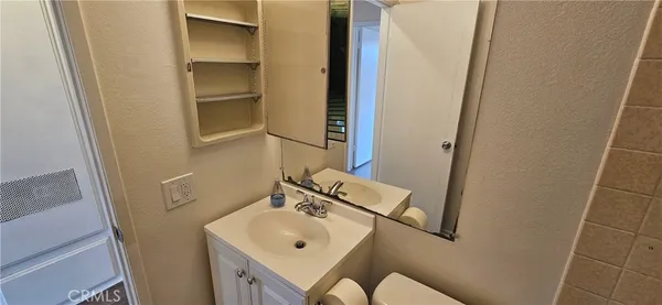 a bathroom with a sink and mirror
