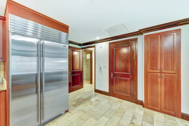 a kitchen with stainless steel appliances granite countertop a refrigerator and a sink