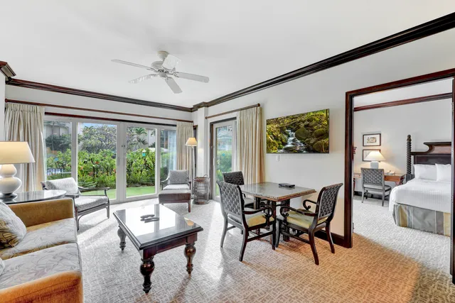 a living room with furniture a table and a large window
