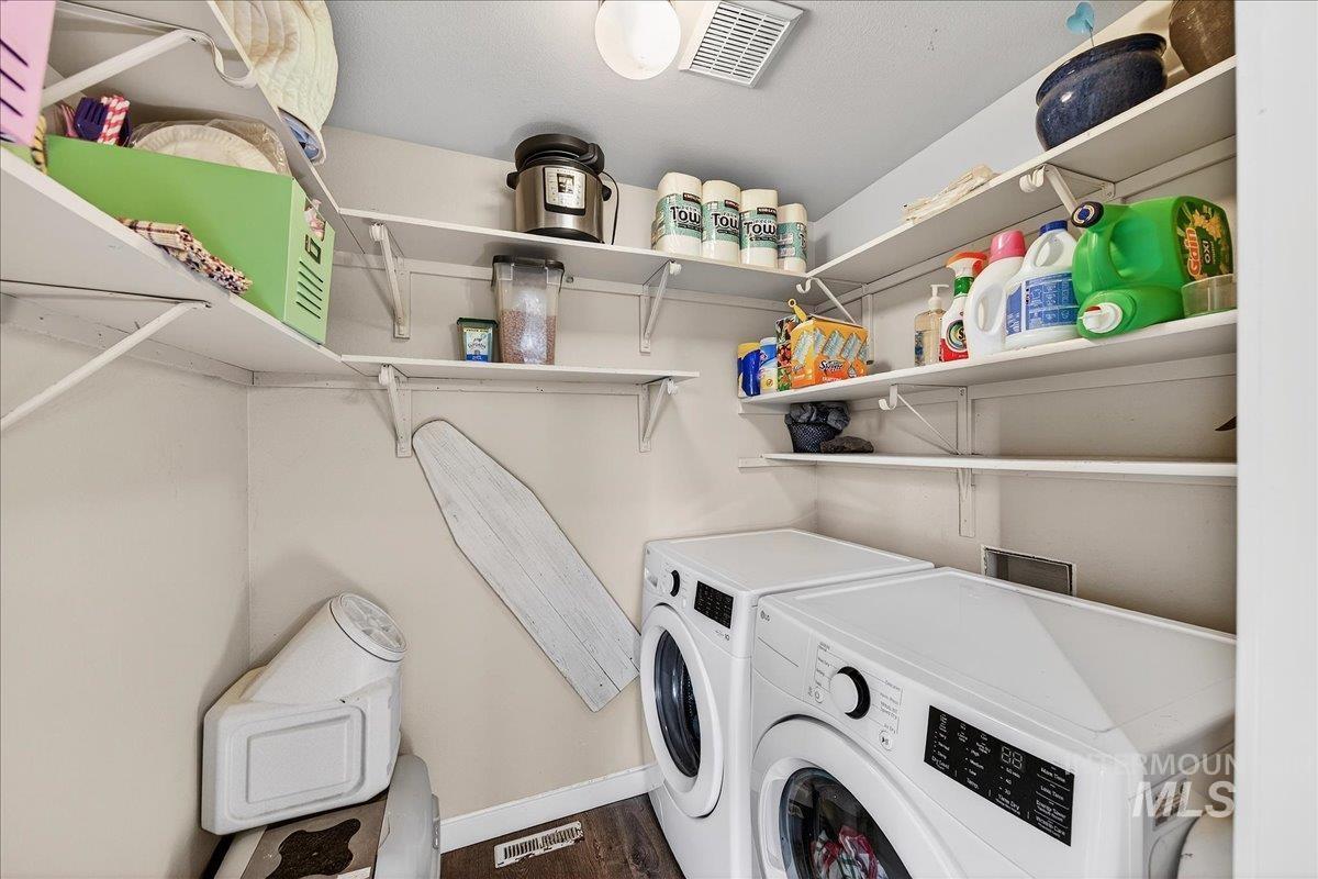 611 Northwest 15th Street Meridian, ID 83642 - Photo 11 of 35 Laundry area featuring separate washer and dryer and dark wood-style flooring