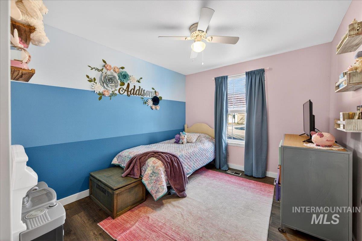 611 Northwest 15th Street Meridian, ID 83642 - Photo 16 of 35 Bedroom featuring dark wood finished floors and a ceiling fan