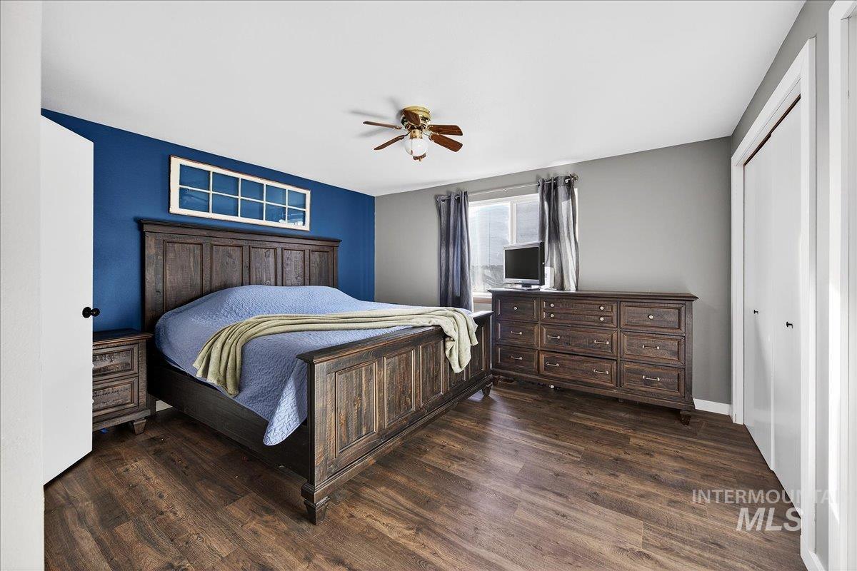 611 Northwest 15th Street Meridian, ID 83642 - Photo 18 of 35 Bedroom with dark wood finished floors, a closet, and ceiling fan