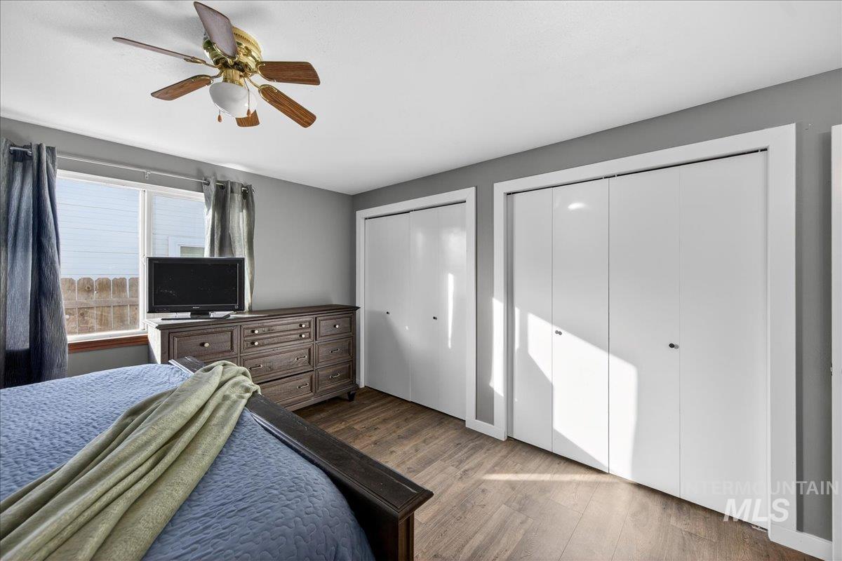 611 Northwest 15th Street Meridian, ID 83642 - Photo 20 of 35 Bedroom featuring two closets, wood finished floors, and ceiling fan