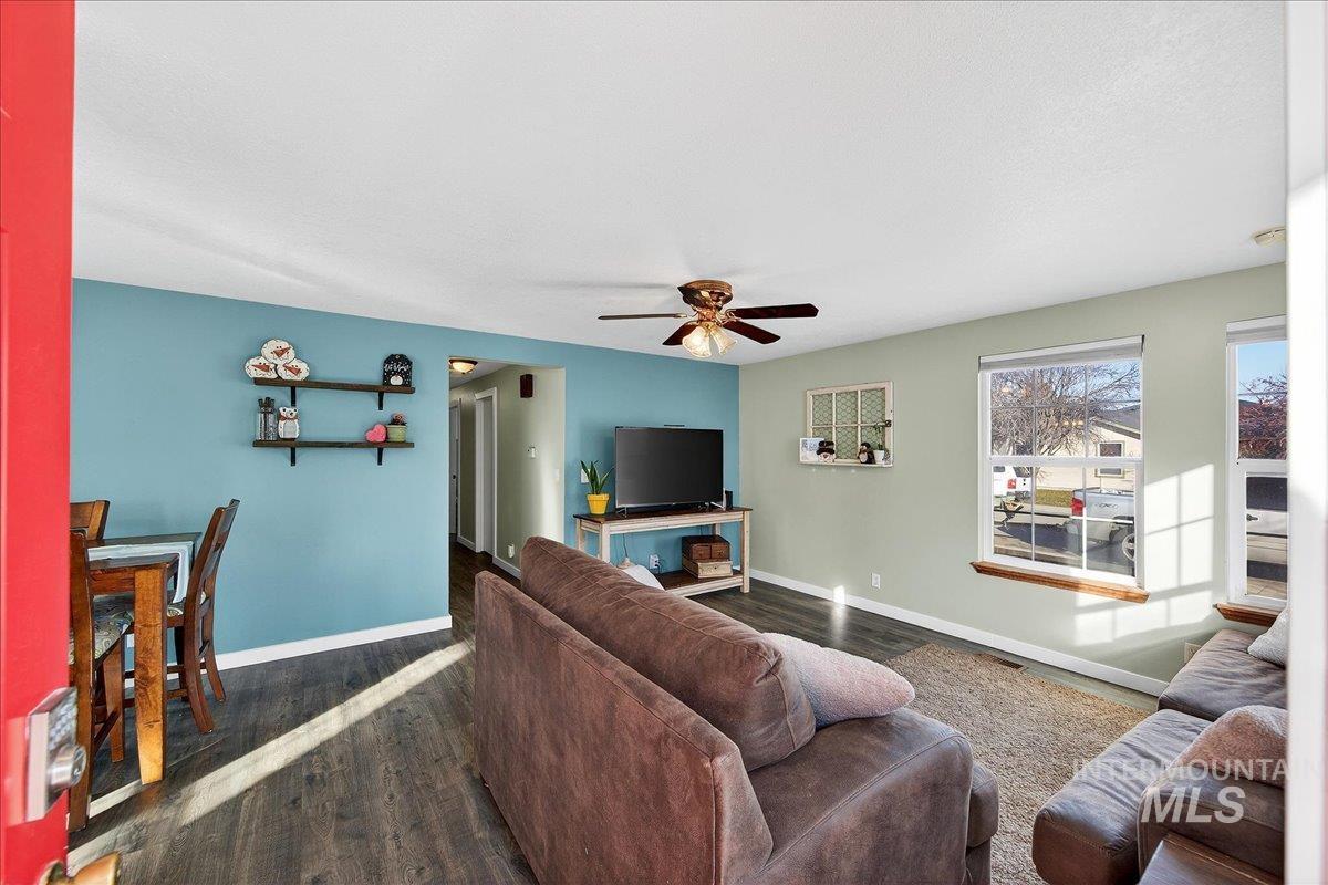 611 Northwest 15th Street Meridian, ID 83642 - Photo 2 of 35 Living area with dark wood finished floors and a ceiling fan