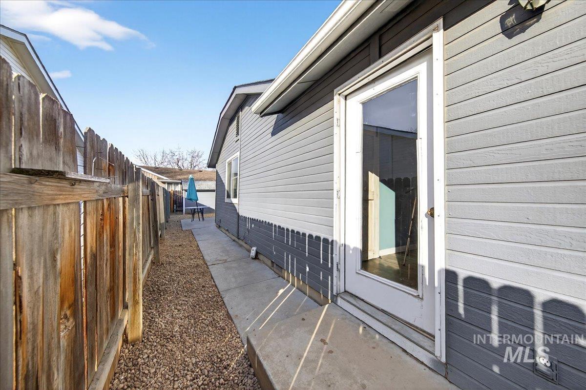611 Northwest 15th Street Meridian, ID 83642 - Photo 24 of 35 View of property exterior with a fenced backyard and crawl space