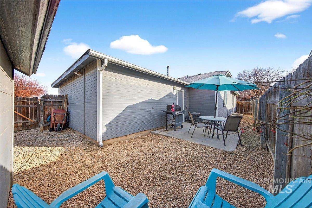 611 Northwest 15th Street Meridian, ID 83642 - Photo 26 of 35 Fenced backyard featuring a patio, a grill, and outdoor dining area