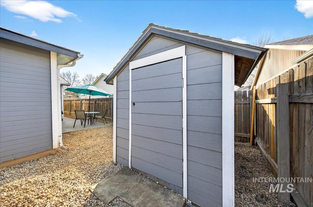 611 Northwest 15th Street Meridian, ID 83642 - Photo 27 of 35 View of shed featuring a fenced backyard and outdoor dining space