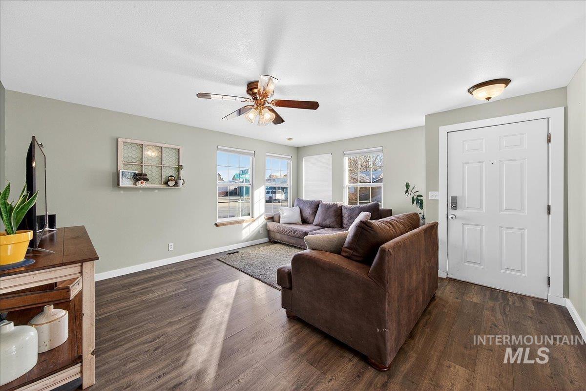 611 Northwest 15th Street Meridian, ID 83642 - Photo 3 of 35 Living room with dark wood-type flooring and a ceiling fan