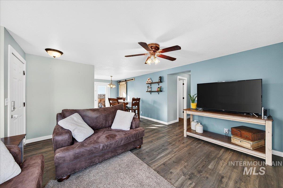 611 Northwest 15th Street Meridian, ID 83642 - Photo 5 of 35 Living room featuring dark wood-style floors and a ceiling fan