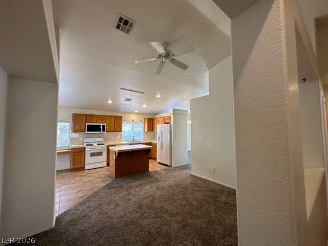 285 Spring Palms Street Henderson, NV 89012 - Photo 15 of 38 Kitchen featuring ceiling fan, visible vents, light countertops, light carpet, and white appliances