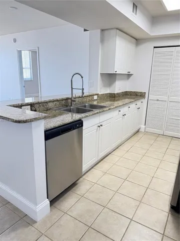 a kitchen with stainless steel appliances granite countertop a sink and a stove