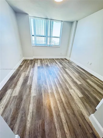 a view of a room with wooden floor and staircase