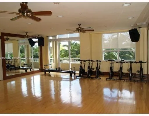 a room with pool table and windows