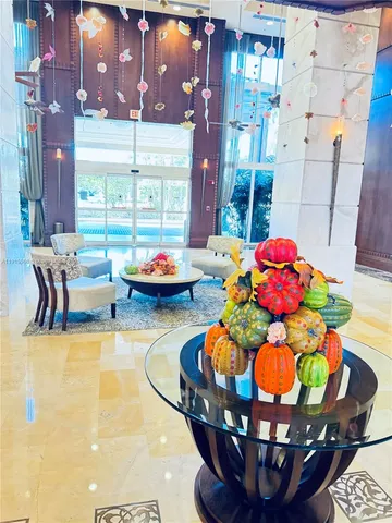 a living room with furniture and floor to ceiling windows