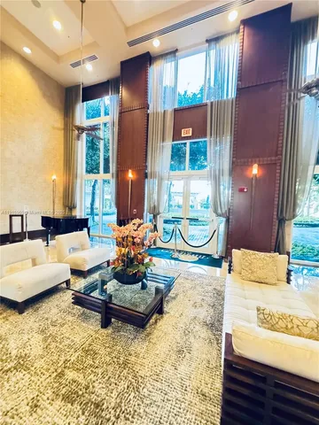 a living room with hard wood floor furniture and a large window