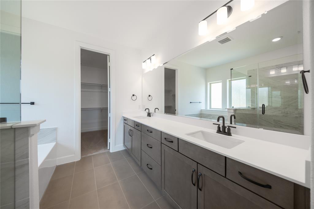 2719 Triumph Court Heath, TX 75126 - Photo 25 of 39 a spacious bathroom with a double vanity sink mirror and double