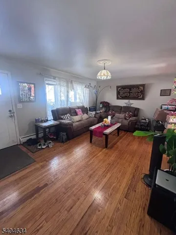a living room with furniture window and wooden floor