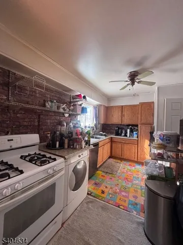 a kitchen with stove top oven and cabinets