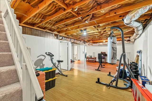 a view of a room with wooden floor and windows