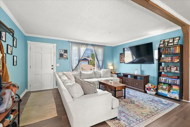 a living room with furniture a rug and a flat screen tv