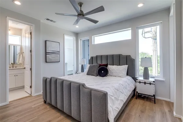 a bedroom with a large bed and a chandelier