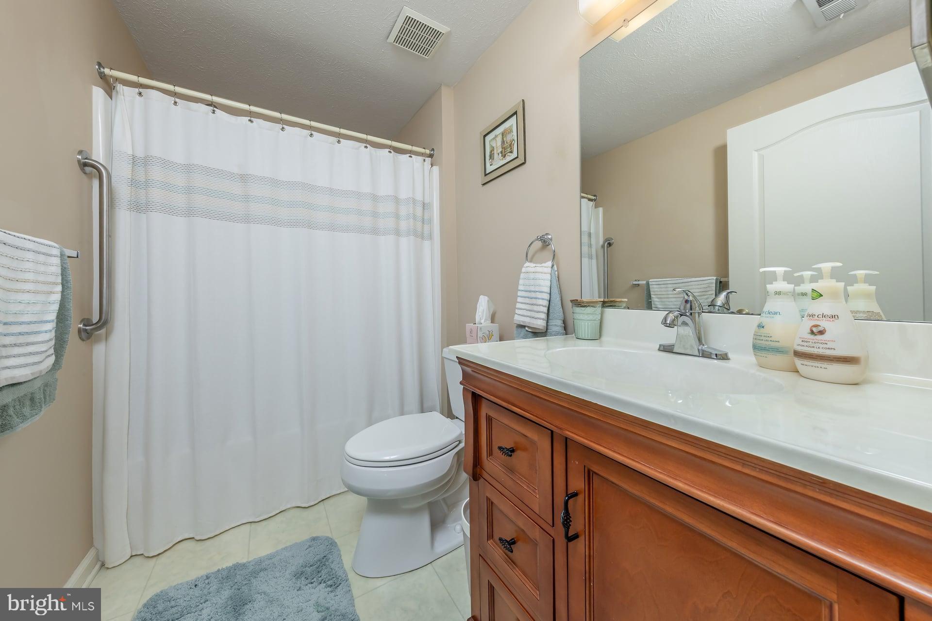 41 Grandview Place Sewell, NJ 08080 - Photo 15 of 23 a bathroom with a sink a toilet and shower curtain