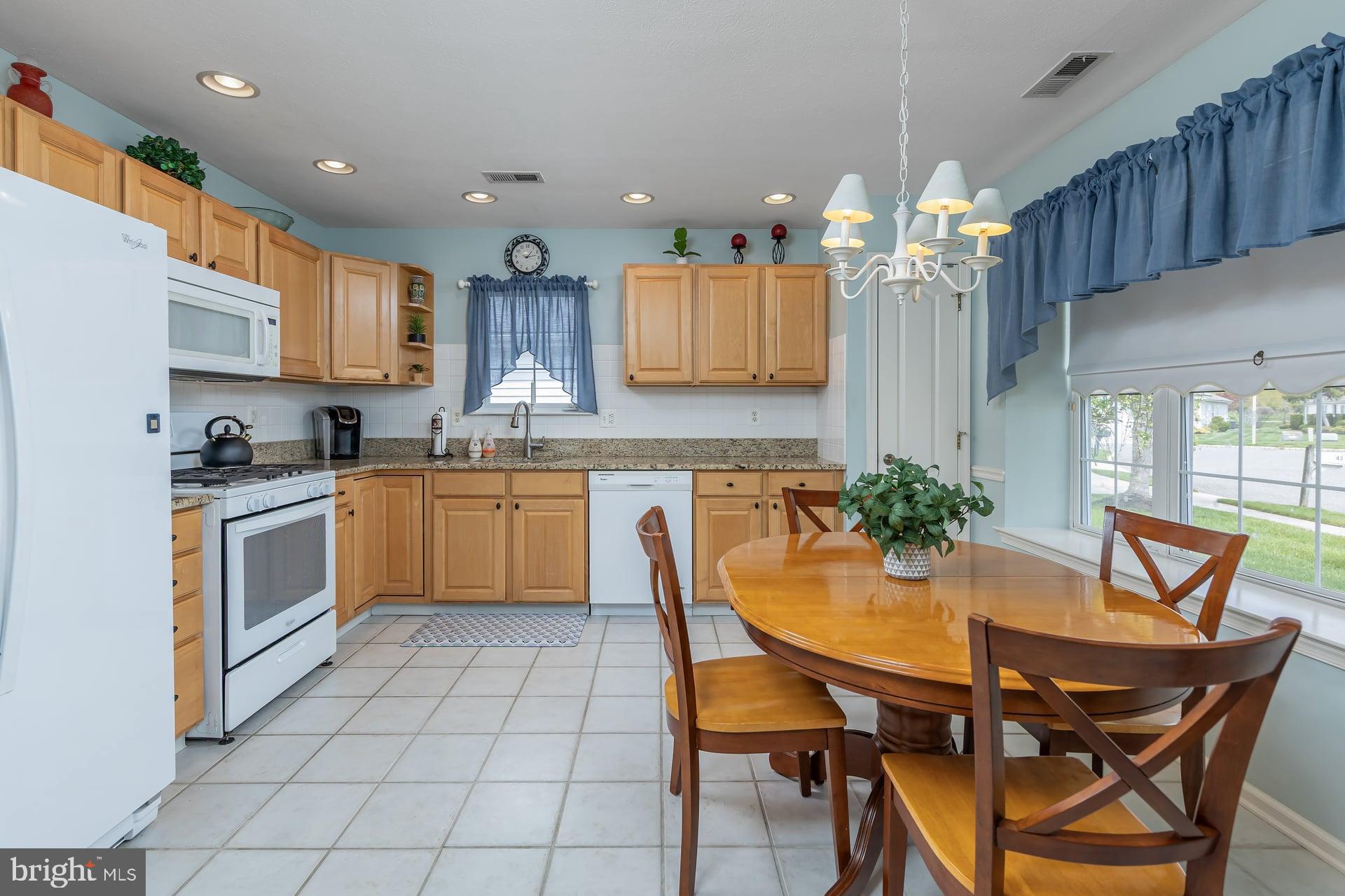 41 Grandview Place Sewell, NJ 08080 - Photo 9 of 23 a kitchen with a table chairs sink and cabinets