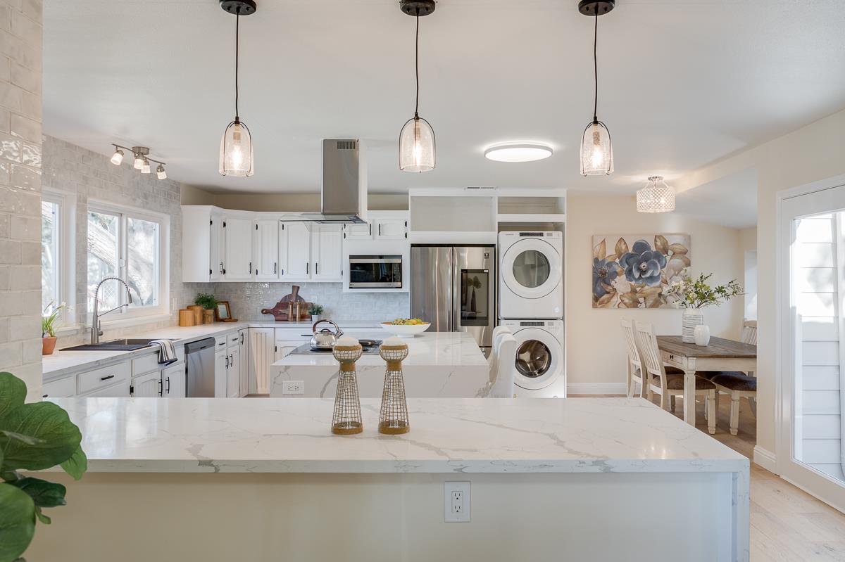 305 Stuart Avenue Pacific Grove, CA 93950 - Photo 15 of 55 a view of a kitchen with kitchen island stainless steel appliances sink and living room view