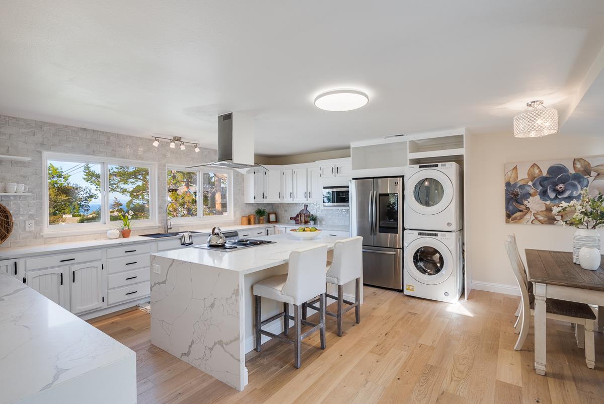 305 Stuart Avenue Pacific Grove, CA 93950 - Photo 16 of 55 a kitchen with a stove a refrigerator and a wooden floors