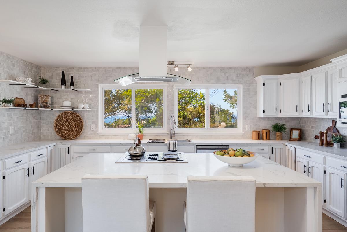305 Stuart Avenue Pacific Grove, CA 93950 - Photo 17 of 55 a kitchen with a sink a stove and white cabinets with wooden floor