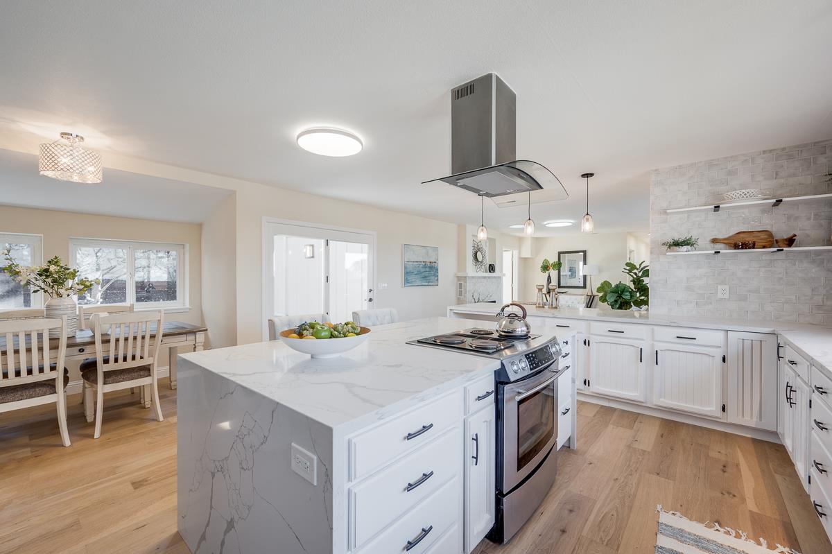 305 Stuart Avenue Pacific Grove, CA 93950 - Photo 20 of 55 a kitchen with a stove a sink a dining table and chairs