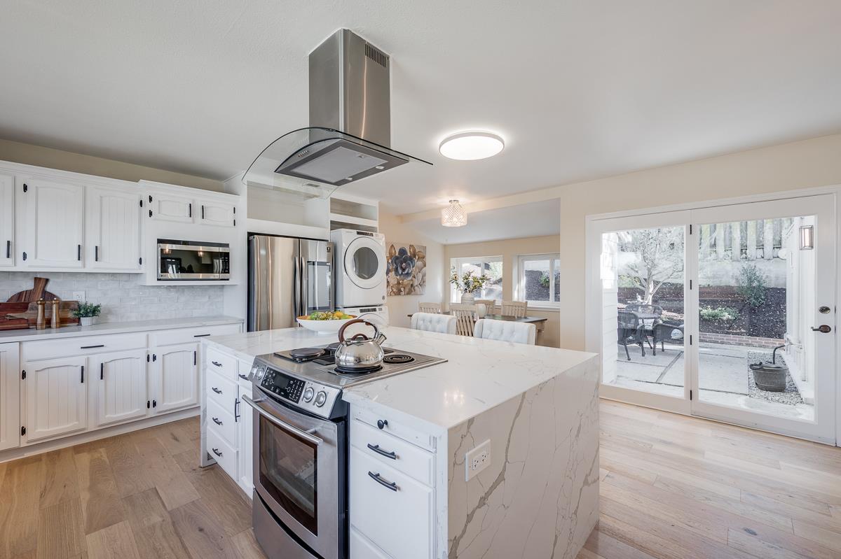 305 Stuart Avenue Pacific Grove, CA 93950 - Photo 21 of 55 a kitchen with stainless steel appliances granite countertop a sink stove and wooden floor