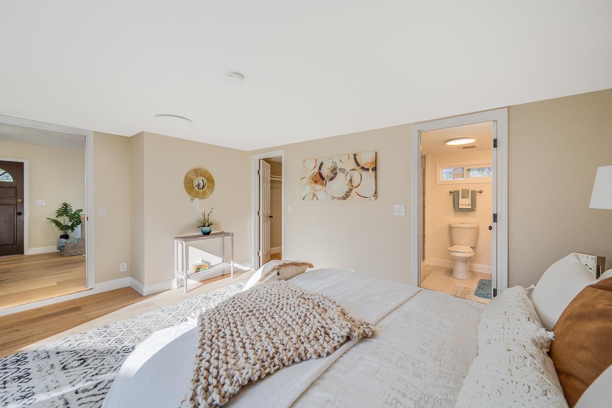 305 Stuart Avenue Pacific Grove, CA 93950 - Photo 26 of 55 a bedroom with a bed and a dresser with rug