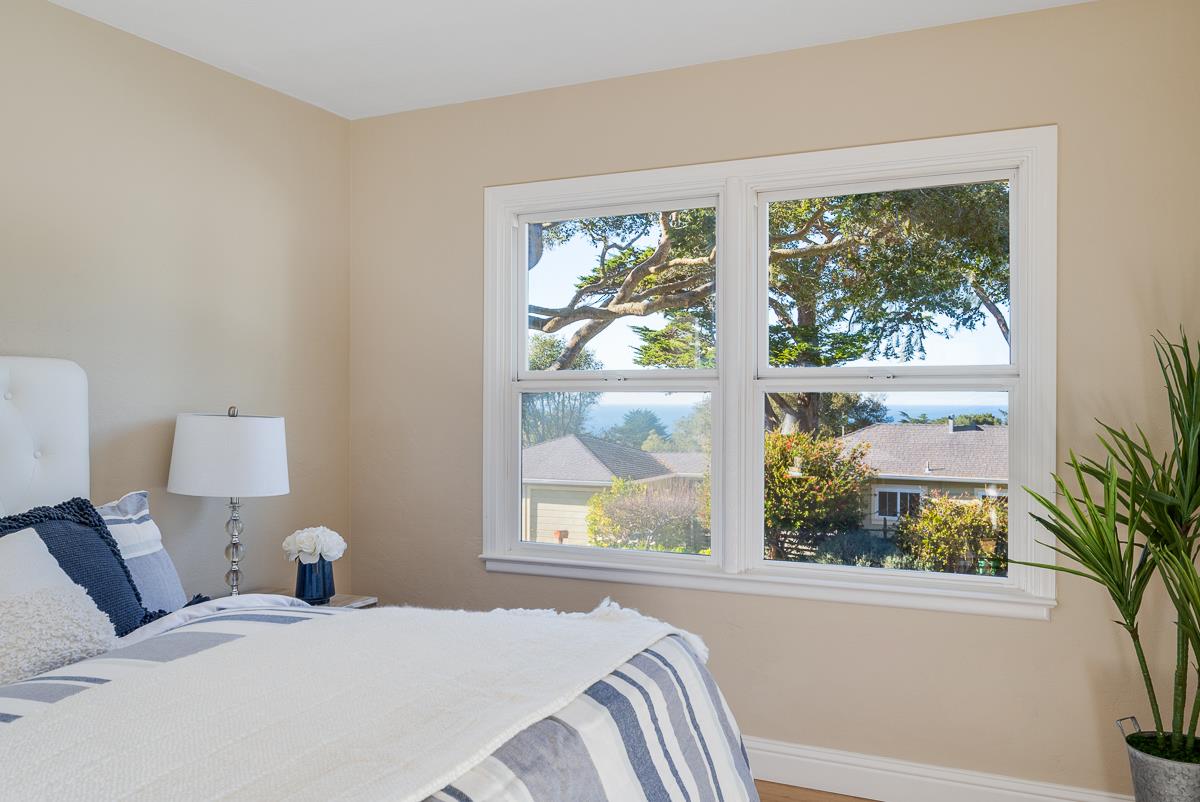 305 Stuart Avenue Pacific Grove, CA 93950 - Photo 34 of 55 a bed sitting in a bedroom next to a window