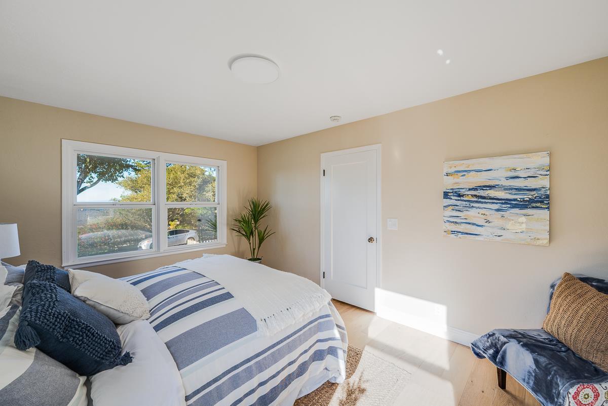 305 Stuart Avenue Pacific Grove, CA 93950 - Photo 36 of 55 a bedroom with a bed and a couch