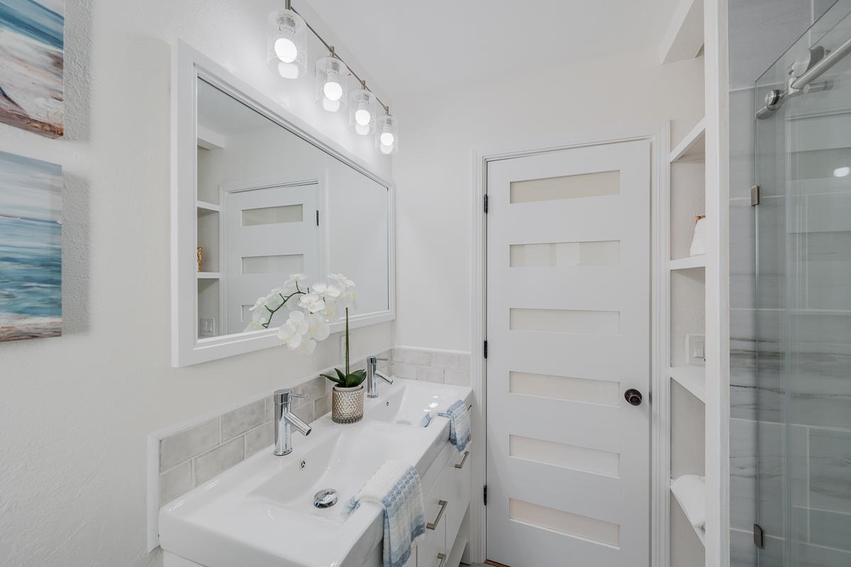 305 Stuart Avenue Pacific Grove, CA 93950 - Photo 40 of 55 a bathroom with a bathtub shower sink and mirror