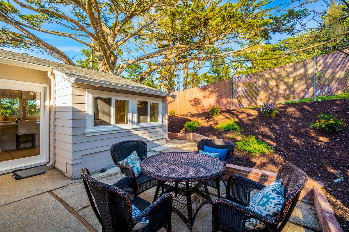 305 Stuart Avenue Pacific Grove, CA 93950 - Photo 46 of 55 a backyard of a house with table and chairs