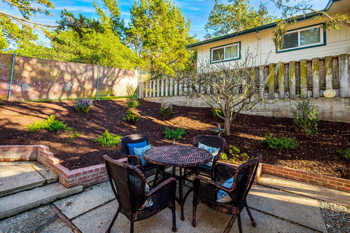 305 Stuart Avenue Pacific Grove, CA 93950 - Photo 47 of 55 a view of a chairs and table in backyard of the house