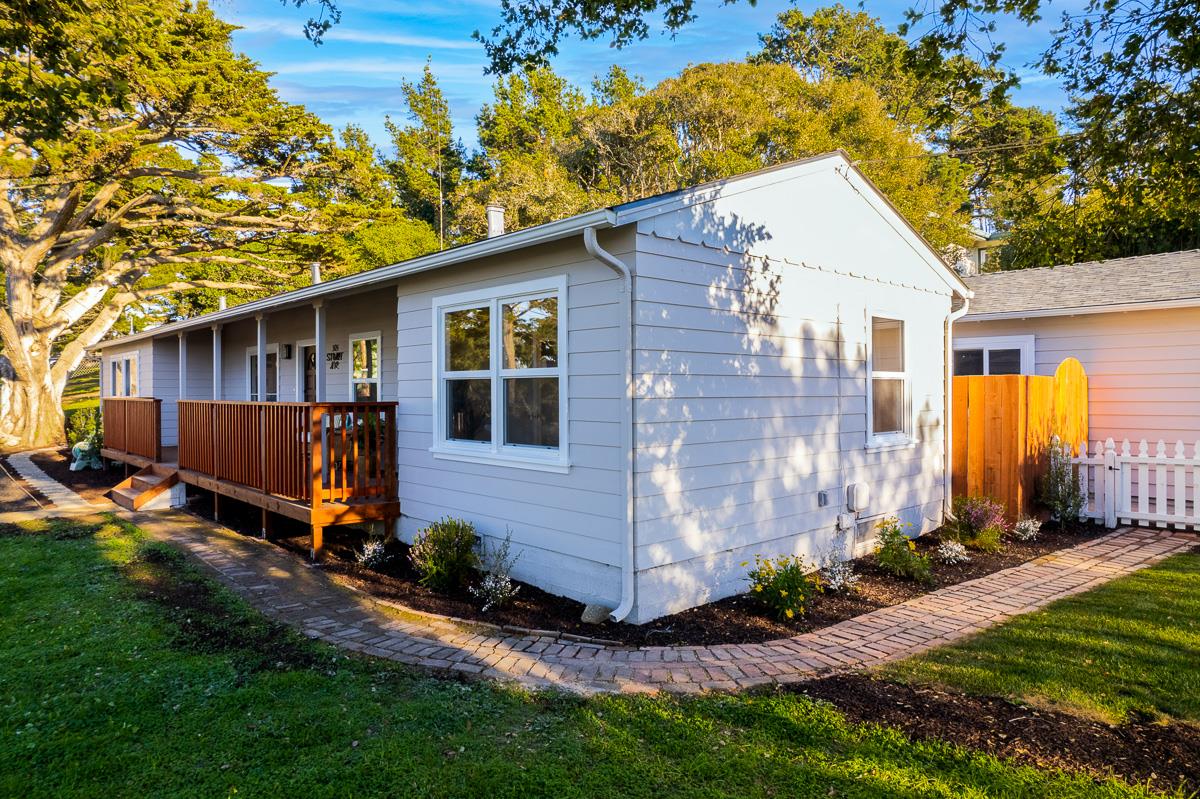 305 Stuart Avenue Pacific Grove, CA 93950 - Photo 7 of 55 a view of backyard with potted plants and a wooden bench