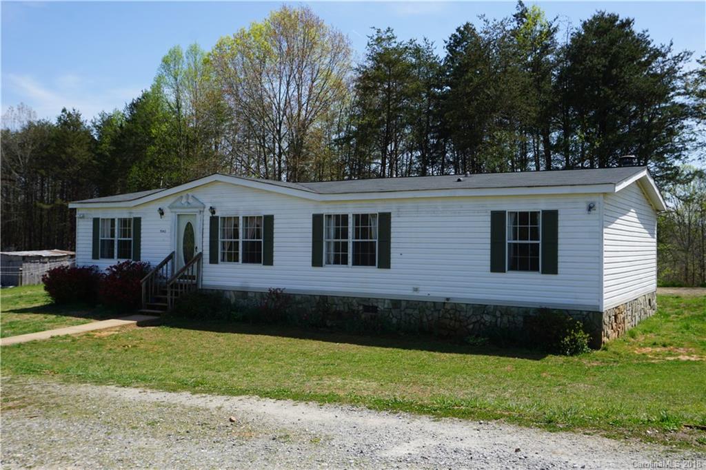 1042 Elliott Road Rutherfordton, NC 28139 - Photo 1 of 33 a view of a house with a yard and a garden