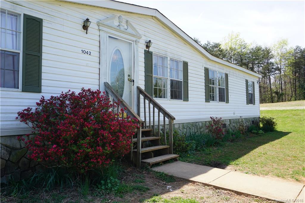 1042 Elliott Road Rutherfordton, NC 28139 - Photo 12 of 33 a front view of a house with a garden