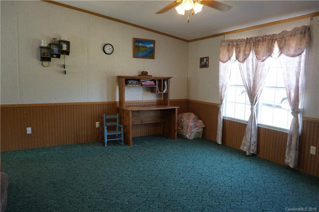 1042 Elliott Road Rutherfordton, NC 28139 - Photo 19 of 33 a view of an empty room with a window and a kitchen