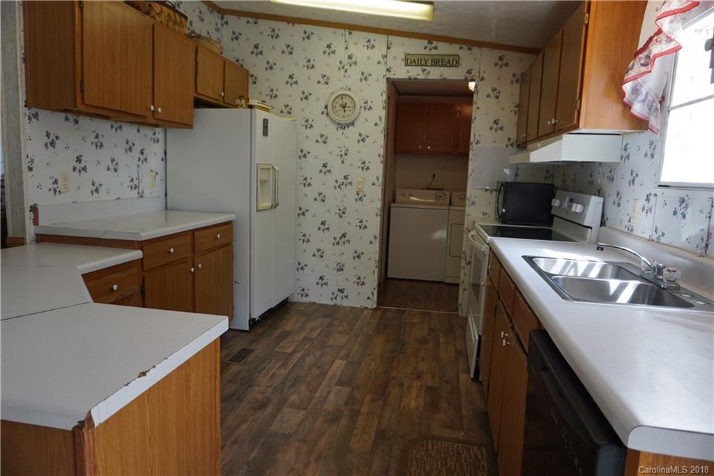 1042 Elliott Road Rutherfordton, NC 28139 - Photo 21 of 33 a kitchen with stainless steel appliances granite countertop a sink stove and refrigerator