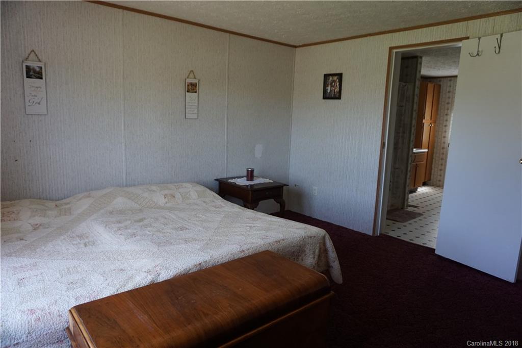 1042 Elliott Road Rutherfordton, NC 28139 - Photo 27 of 33 a bedroom with a bed and wooden floor