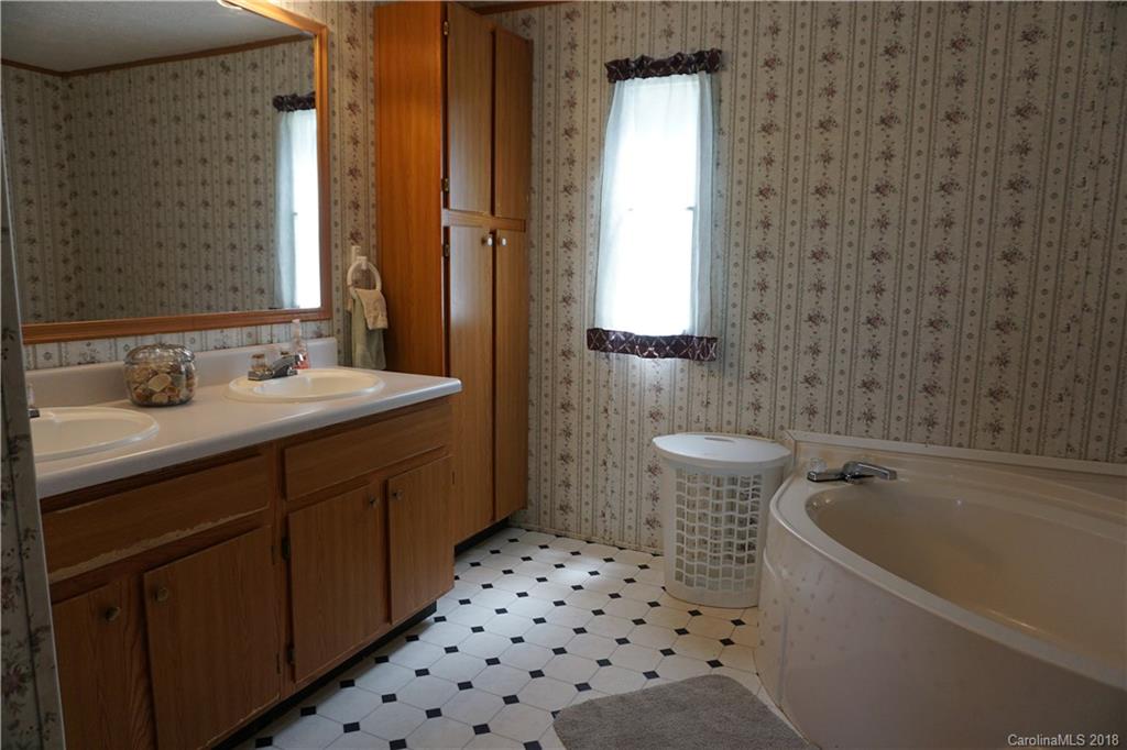 1042 Elliott Road Rutherfordton, NC 28139 - Photo 28 of 33 a bathroom with a sink a toilet and shower